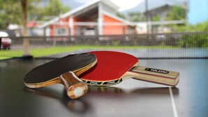 Two table tennis paddles on a table with a net in the background. - Apartment 8: Condos Vista al Volcan - Second Floor (La Fortuna)