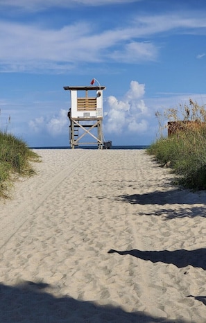 Beach safety is ensured by this lifeguard tower, standing watch over the sandy shoreline.