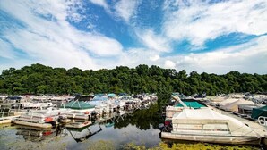A marina with boats docked, surrounded by a forested area. - Quiet & Peaceful (Galena)