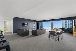 Relax in this stylish living area with a sofa, dining table, and flat-screen TV.