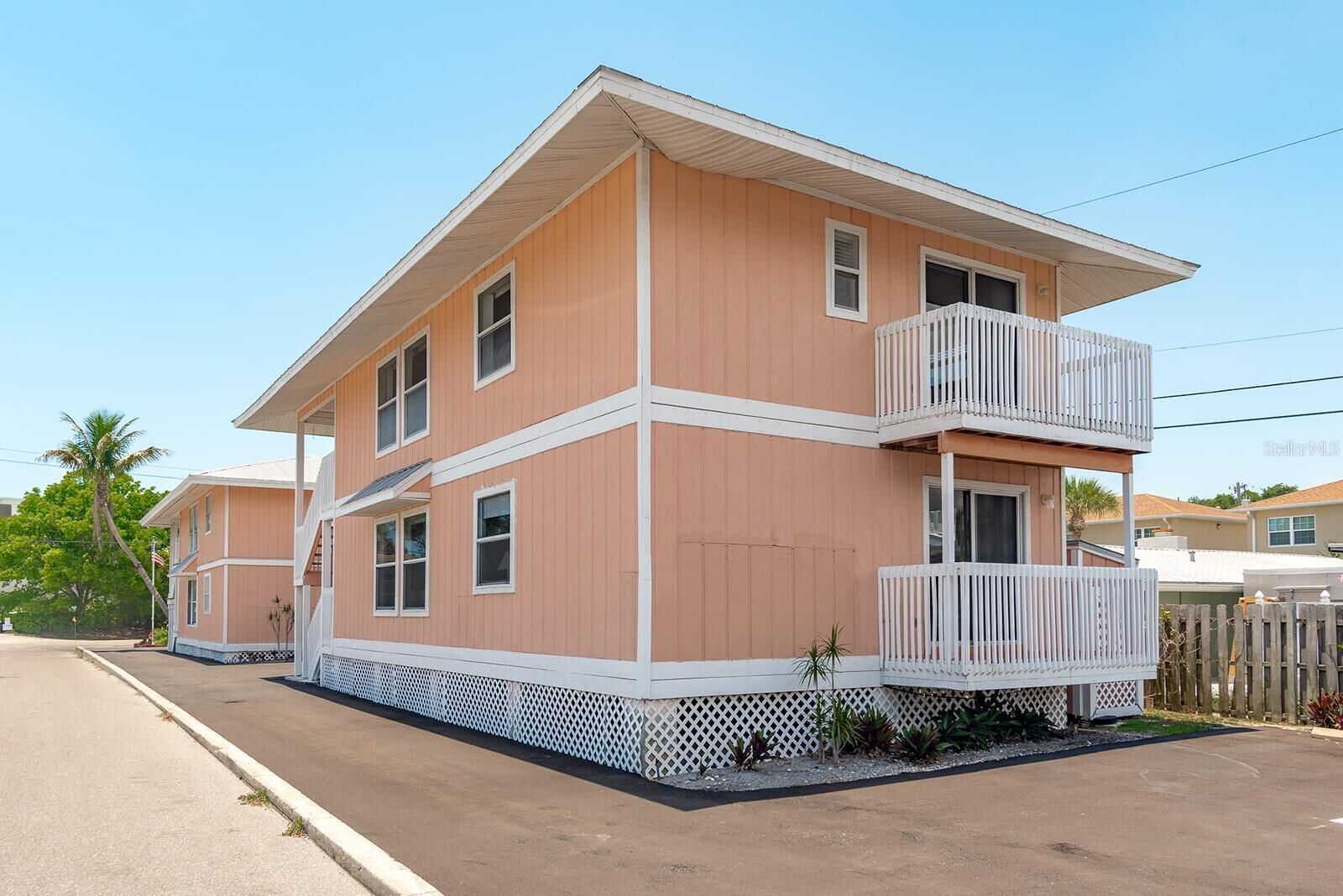 A two-story house with a balcony on the second floor.