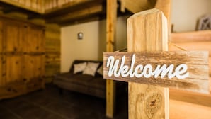 A wooden sign with the word "Welcome" in white letters, indicating a reception area.