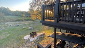 A wooden deck with a fire pit and outdoor seating. - The Lodge on Salado Creek includes golf cart (Salado)