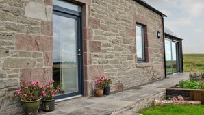A stone building with large windows and a stone pathway leading to the entrance. - 3 bedroom accommodation in Dundee (Dundee)