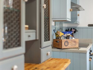 A kitchen with a wooden countertop, a box labeled 'Gift,' and various food items.