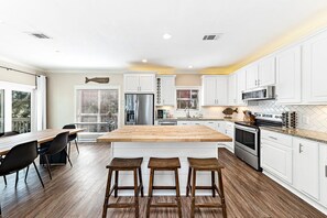 Enjoy cooking in this well-lit kitchen with a large island and stainless steel appliances.