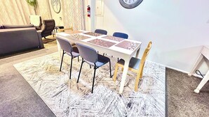 A dining area with a table, chairs, and a clock on the wall. - 1,200 SqFt Comfy Home, 15 min to Boulder (Broomfield)