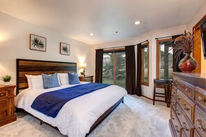 Lower Level Master Bedroom with king bed, 32" TV, private patio access, and en suite bathroom