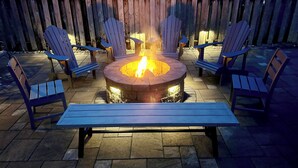 A fire pit with chairs and a bench arranged around it. - OCEANS OF LOVIN` at Seaside Beach - Peek of Ocean 150ft to Beach (Seaside)