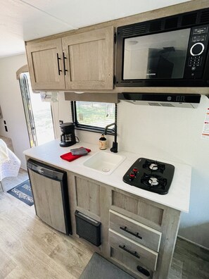 Fridge, stovetop, coffee/tea maker, toaster - Gennesis RV is located in Lost Pines Near Bastrop Lake (Bastrop)