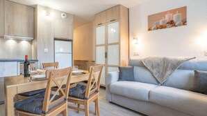 Eine moderne Wohnung mit Essbereich, Küche und Wohnzimmer.