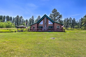A lodge with a stone chimney, wooden exterior, and a deck with a gazebo. - Idyllic Hill City Home - Hike, Bike & ATV! (Hill City)