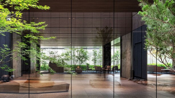 A modern interior with a glass partition, indoor plants, and a seating area. - Richmond Hotel Premier Kyoto Shijo (Kyoto)