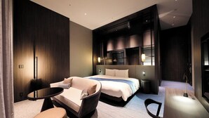 A modern hotel room with a large bed, a sofa, a small round table, and a desk. - Richmond Hotel Premier Kyoto Shijo (Kyoto)