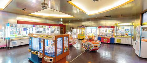 An indoor arcade with various claw machines and game booths.
