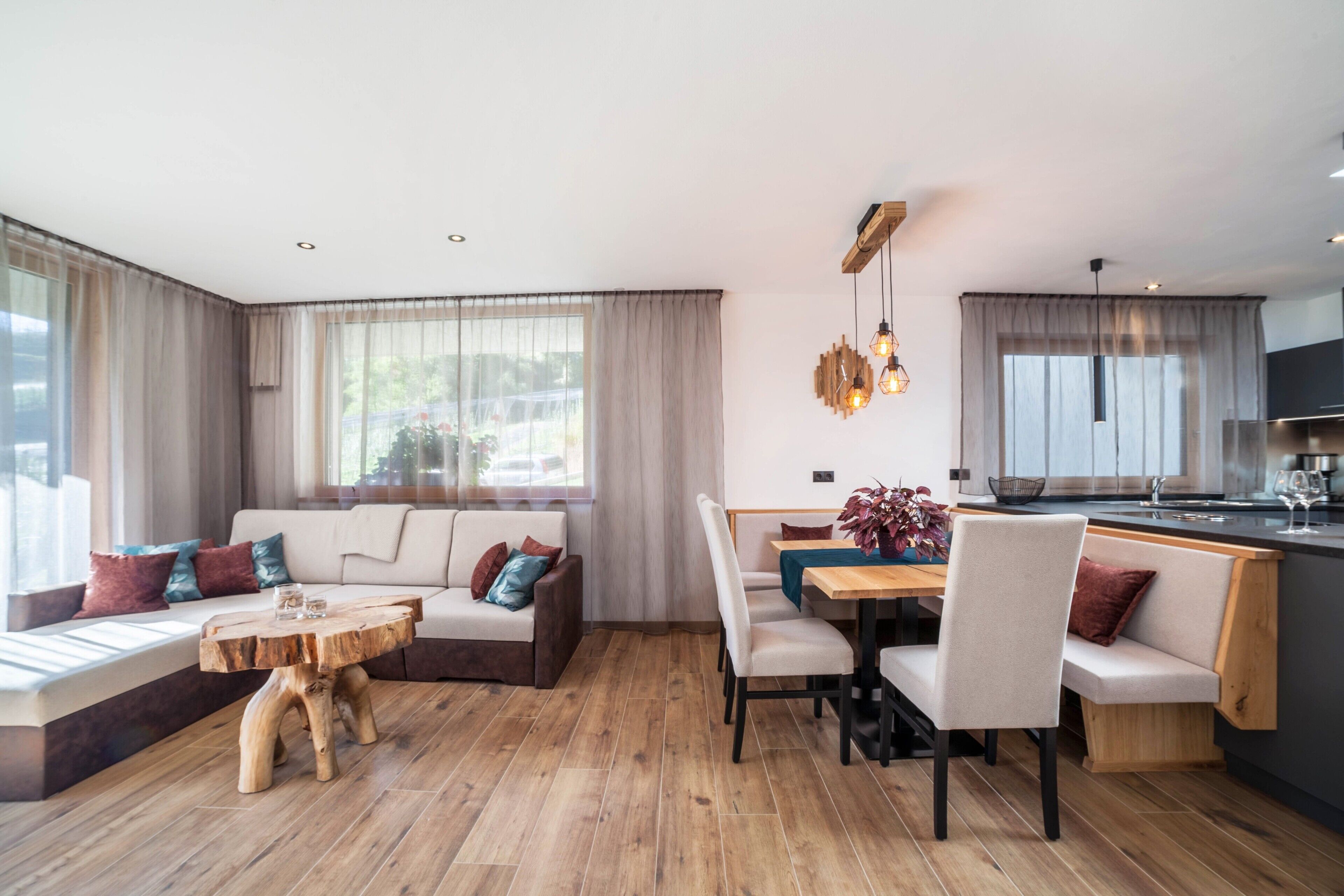 A modern living room with a sofa, dining table, and wooden coffee table.