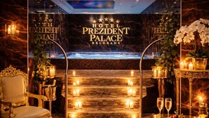 A luxurious hotel lobby with a grand fireplace, elegant seating, and a clear view of the hotel name. - Prezident Palace Belgrade - Rooftop Pool & Spa Hotel (Belgrade)