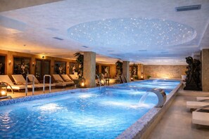 A large indoor swimming pool with multiple lanes, lounge chairs, and a ceiling with a starry light display. - Prezident Palace Belgrade - Rooftop Pool & Spa Hotel (Belgrade)