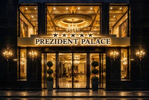 The exterior of the President Palace hotel with a grand entrance, a chandelier, and a sign with stars. - Prezident Palace Belgrade - Rooftop Pool & Spa Hotel (Belgrade)
