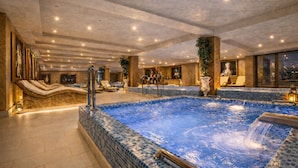 A large indoor swimming pool with multiple seating areas and a jacuzzi. - Prezident Palace Belgrade - Rooftop Pool & Spa Hotel (Belgrade)