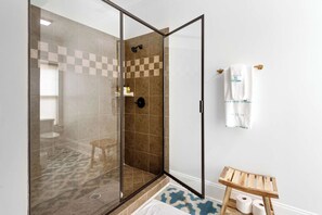 Bathtub, hair dryer, towels, shampoo