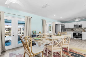 A modern kitchen with white cabinets, a stainless steel oven, and a microwave.
