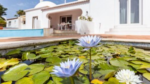 A white building with a pool and two water lilies in the foreground. - Villa with 7 bedrooms and private pool in Alporchinhos, walking distance to beach (Porches)