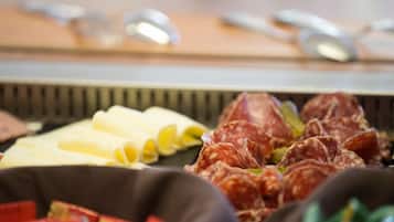 A charcuterie board with various meats and cheeses.