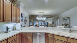A spacious kitchen with wooden cabinets, a stainless steel dishwasher, and a large island with a sink. - 8126 Wendover Dunes - Palmetto Dunes Oceanside Community (Hilton Head Island)