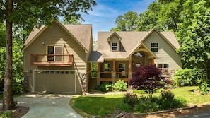 A two-story house with a front porch, a garage, and a landscaped yard. - Respite Ridge - Game Room-Fireplace-Stunning View (Young Harris)
