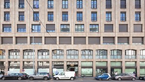 A multi-story building with a uniform facade, multiple windows, and balconies. - easyhomes - Madonnina view (Milan)