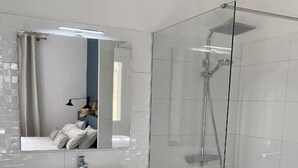 A modern bathroom with a glass shower enclosure, a white sink, and a wooden vanity. - LE PONT Junior Luxury Suite with private Jacuzzi (Martignargues)