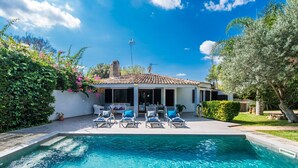 A poolside area with lounge chairs and a clear blue pool. - House with pool garden Casa Pequeña in Mallorca (Crestatx)