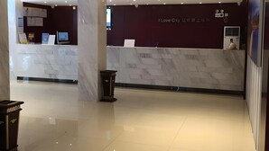 A modern hotel lobby with a reception desk, marble flooring, and recessed lighting. - City Comfort Inn (Guangzhou Taihe Plaza) (Guangzhou)