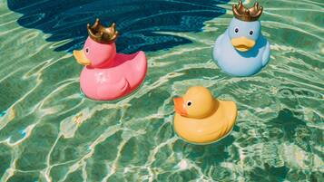 Three rubber ducks floating in clear water.