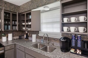A kitchen with granite countertops, a stainless steel sink, and a window with blinds. - 30% OFF Arcade Mania - Large Yard 4 pets! 4 TVs (Plano)