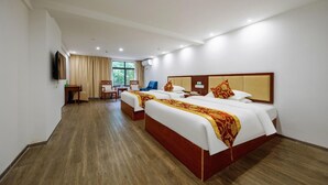 A hotel room with two beds, a desk, a chair, a TV, and a window with curtains. - Greentree Inn Suzhou Kunshan Huaqiao Metro Station Express Hotel (Suzhou)