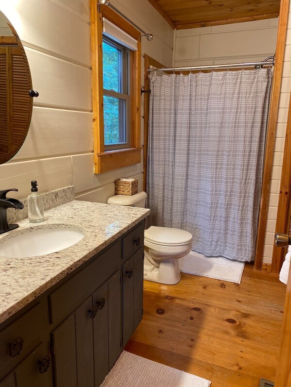 A bathroom with two sinks, a toilet, a window, and a shower curtain. - The Hygge at Blue Ridge - Beautiful Mtn view, 3 Fire types, Hot Tub (Blue Ridge)