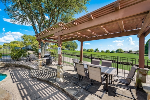 Backyard with heated pool, spa, grill, patio and outdoor dining.