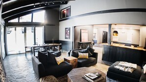 A modern interior with a reception desk, sofas, and a dining area. - Chamonix - Year-round Fun w/ Shared Pool! (Mammoth Lakes)