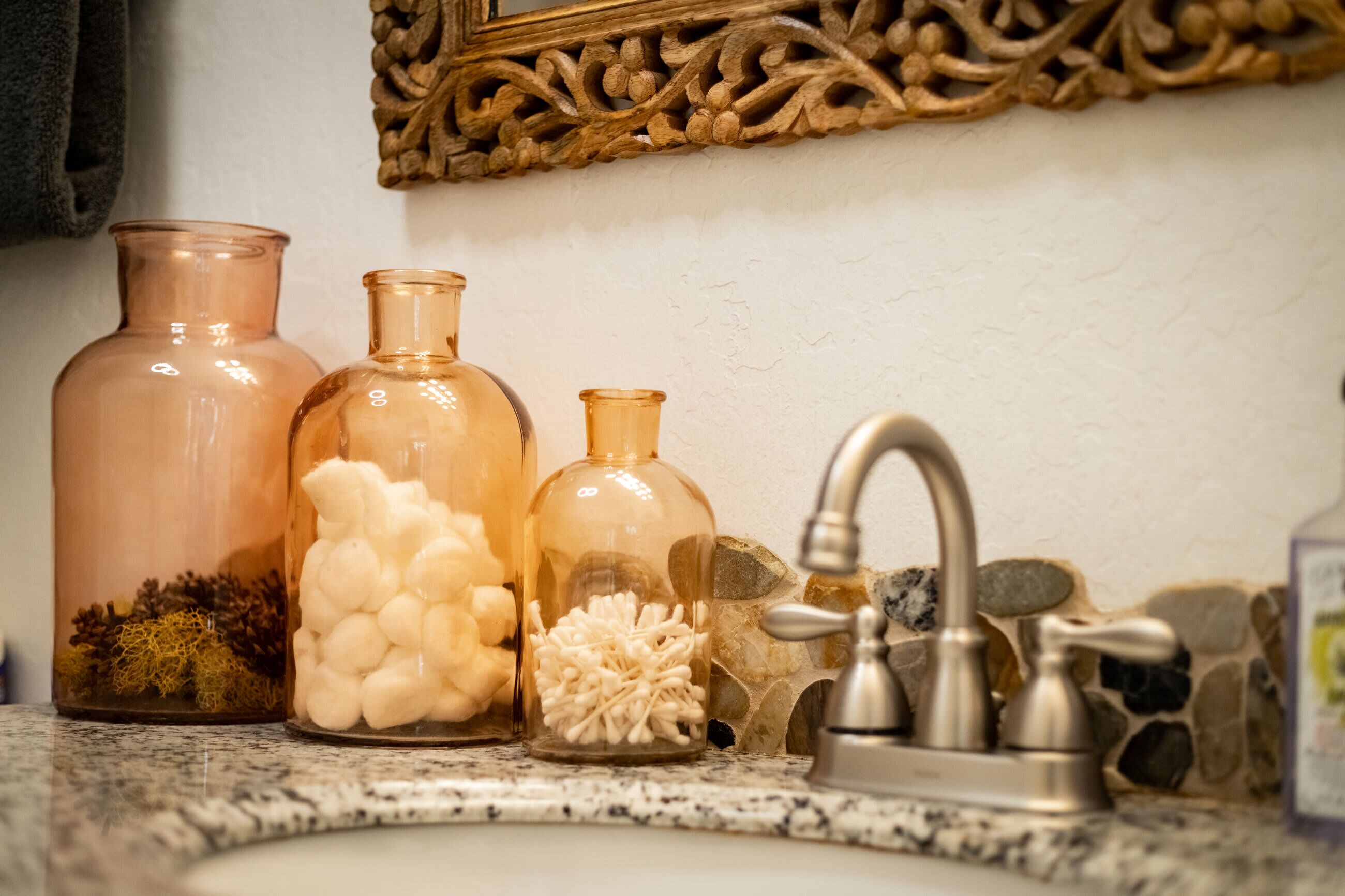 Three glass containers with different contents on a kitchen counter.