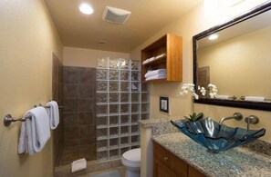 A bathroom with a glass shower enclosure, a marble sink with a glass bowl, and a wooden medicine cabinet above the sink. - The Beach Villas w/ Pool Hot Tub & A/c! (Kailua-Kona)