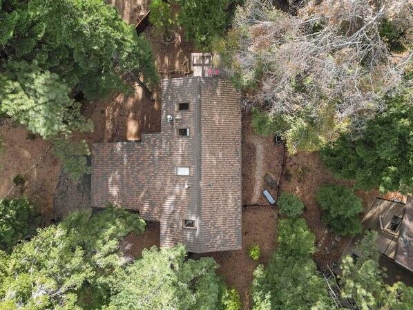 An aerial view of a house surrounded by dense trees, with a sloped roof and multiple windows. - Sundance Foosball Table, Bbq, Near West Beach (Carnelian Bay)