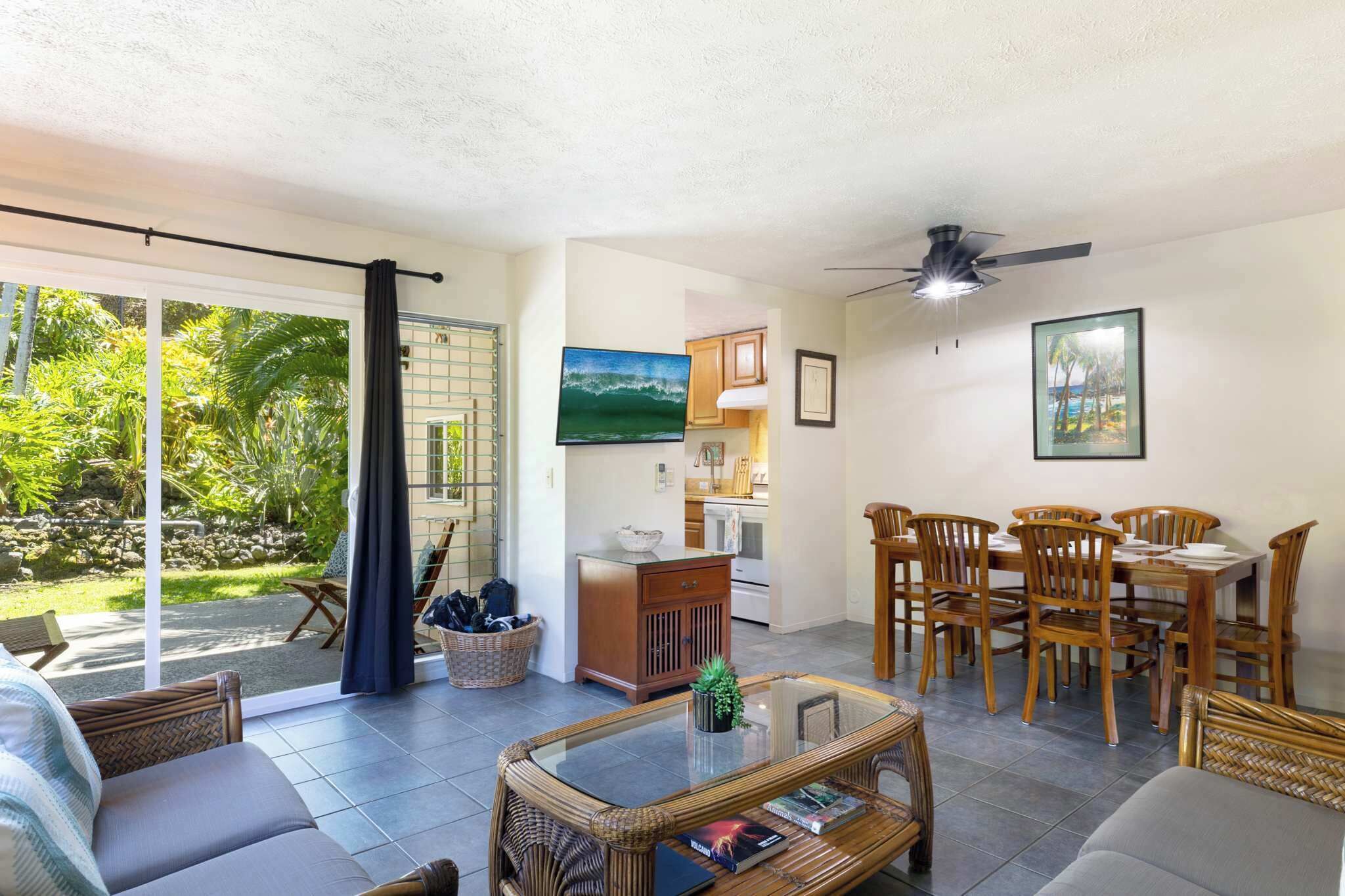 A spacious living area with a dining set, a sofa, and a coffee table.