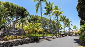 A sign for Keauhou Kona Surf and Racquet Club at 78-6800 Alii Drive, surrounded by tropical vegetation and palm trees. - Surf & Racquet Club #24 New Beds, New You! (Kailua-Kona)