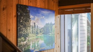 A painting of a serene lake surrounded by trees and mountains on a wooden wall. - Whiskey Rock (South Lake Tahoe)