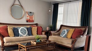 A living room with a sofa, coffee table, and a rug.