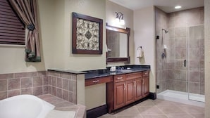 A bathroom with a bathtub, vanity, and shower.