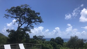A pool area with lounge chairs and a view of the ocean. - Casa Sandia- Ocean & Mountain Views- Home + Studio (Pastillas)