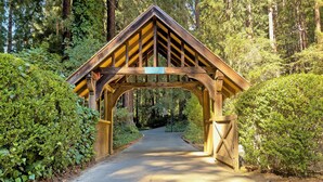 A wooden covered bridge with a sign reading "21840" in a forested area. - River Queen: Historic 5 Bed/5.5 Bath, Dock, Boats + New Hot Tub! (Monte Rio)
